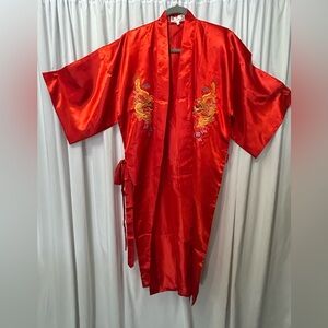 Kimono is red and embroidered beautifully. It is a small size.